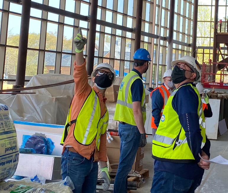 Samir Taylor (left) reviews construction progress.