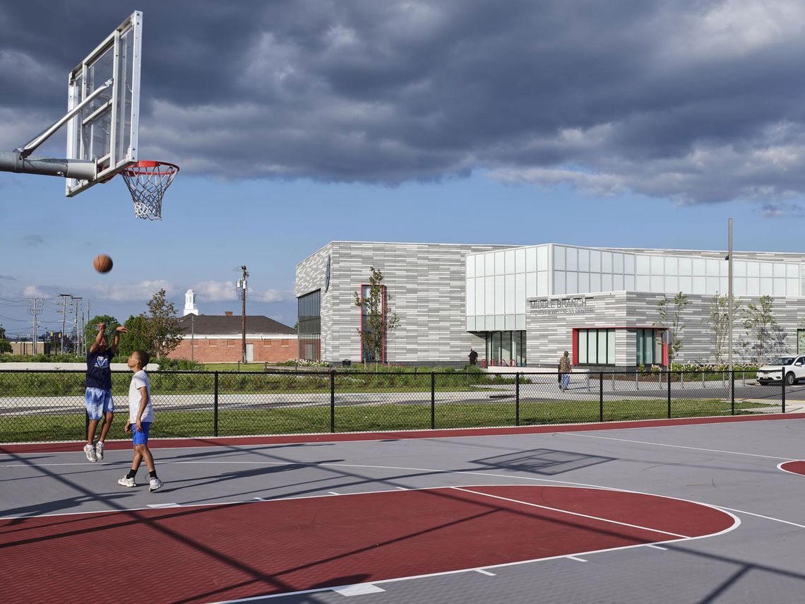 An iconic beacon formed by two volumes—one high, one low—joined by a translucent nexus, the building anchors Reedbird Park and is the new heart of the community.